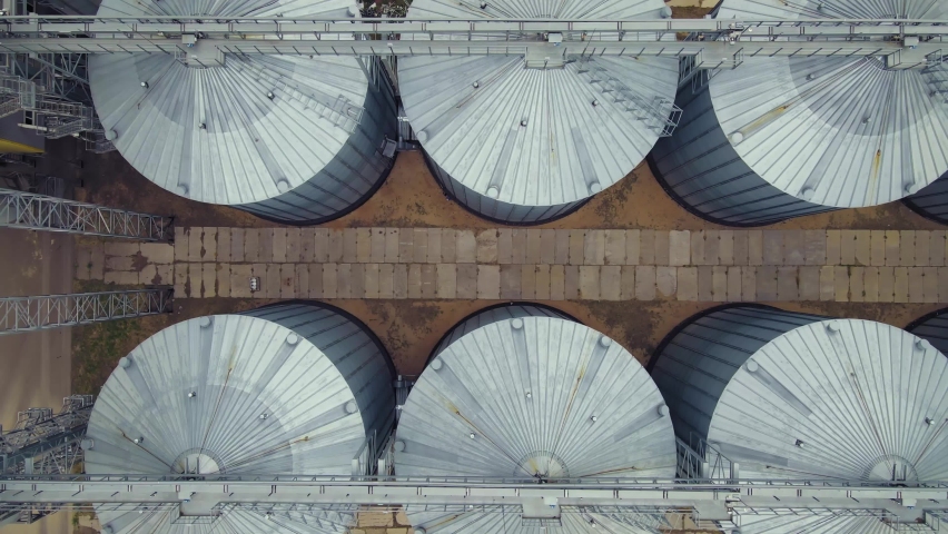 Grain storage elevator, Large metal hangar for grain. Silo with grain Aerial view Royalty-Free Stock Footage #1077363674
