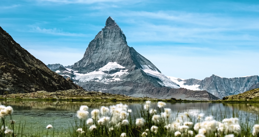 Close-up view of Matterhorn behind mountain flowers in Riffelsee Lake Royalty-Free Stock Footage #1077363704