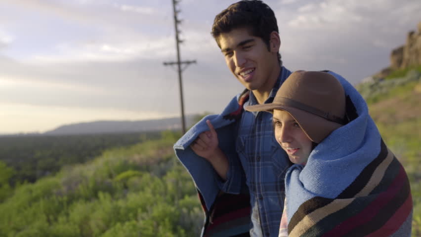 Young Couple Wrapped In Blanket, Watch The Sunset Over The Salt Lake Valley (Slow Motion) 