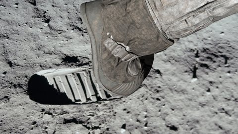 Lunar astronaut walking on the moon's surface and leaves a footprint in the lunar soil. 3d rendering. Some Elements of this video furnished by NASA.
