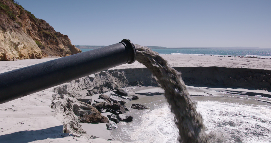 Dredged sand being pumped on to a reclaimed beach Royalty-Free Stock Footage #1077368972