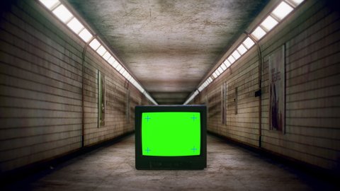 Green Screen TV Spooky Underground Corridor Subway Hallway Zoom In. Walking Through an empty eerie subway corridor with a green screen television. Scary scene