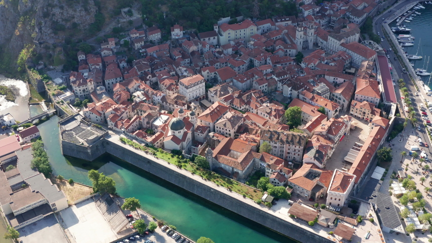 Old town Kotor Montenegro on the coast of Boka bay in the Mediterranean. Vacation destination and tourist trap in Europe. Aerial drone view of waterfront and stone houses on a sunny summer day. Royalty-Free Stock Footage #1077374969