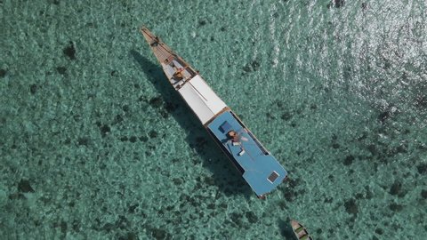 Boat Tour Over Clear Blue Sea In Labuan Bajo, Nusa Tenggara, Indonesia. aerial top-down