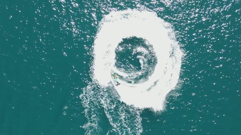 Speed boat driving in circle forming sea doughnuts and making waves big white foam in the middle of the Adriatic sea, Croatia top holiday Summer Europe destination