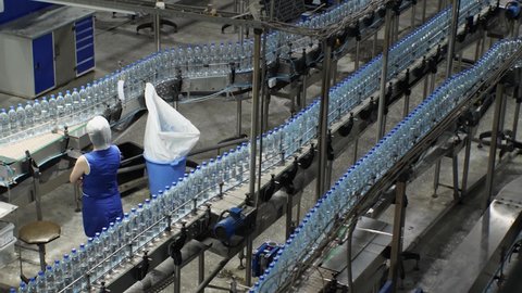 Conveyor line with plastic bottles at a plant for the production of mineral water and soft drinks