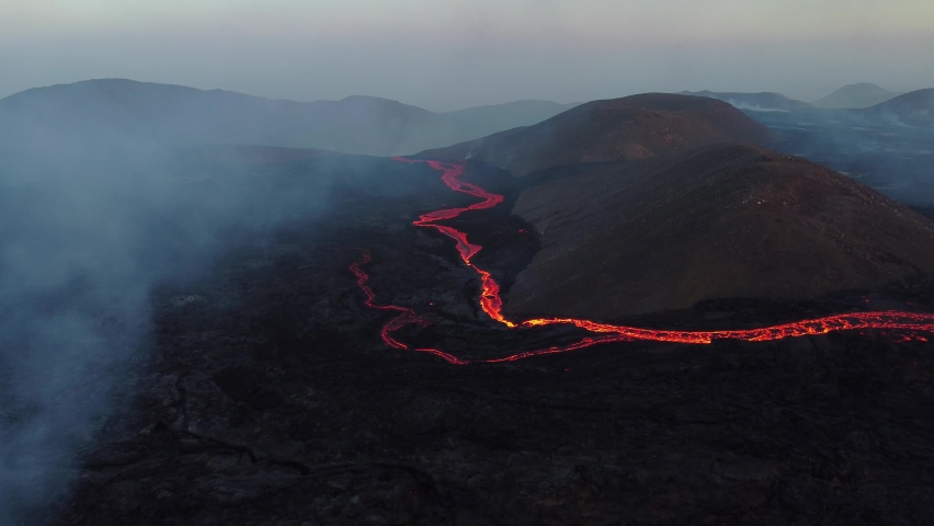 Incredible aerial of the dramatic volcanic eruption of the Fagradalsfjall (Geldingadalur) volcano eruption in Reykjanes peninsula Iceland. Flowing lava. Earthquakes under the Eyjafjallajokull glacier