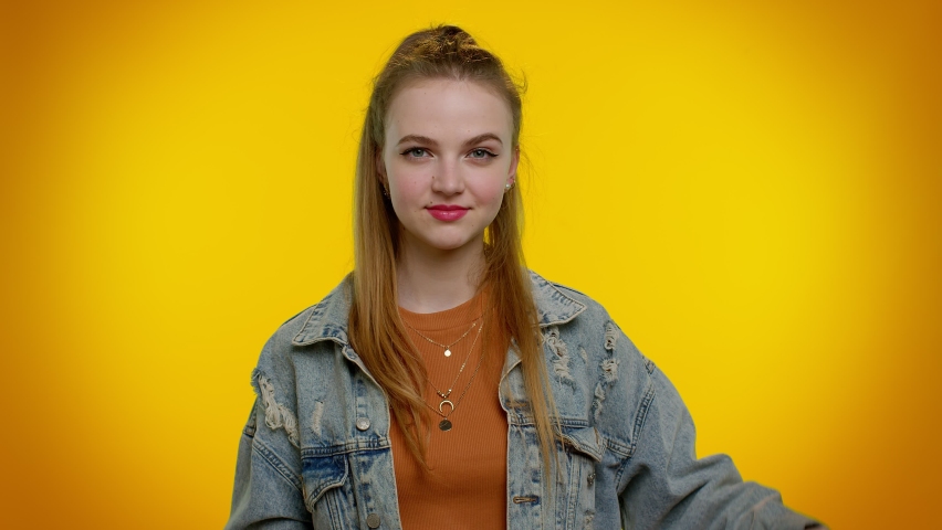 Cheerful teenager girl showing shopping bags and Up To 40 Percent Off inscriptions banner text. Black Friday. Good holiday discounts, low prices for shopping. Young woman posing on yellow background