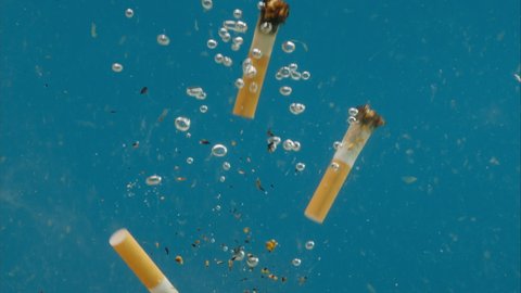 Cigarette butts floating, Trash in ocean water, sea pollution, ecology problems, waste and garbage underwater, polluted bad environment