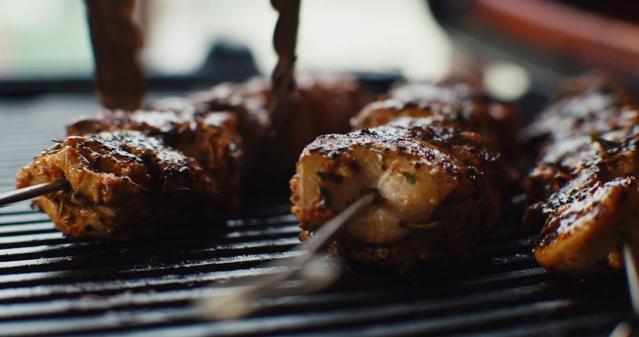 Chicken souvlaki skewers cooking on a hot grill. Shot on a cinema camera. Royalty-Free Stock Footage #1077399380