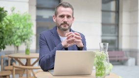 Man Smiling at Camera While using Laptop Outdoor - Powered by Shutterstock - Get 15% off with code: PIKWIZARD15