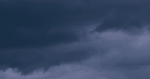 Rainy dark clouds time lapse in horizon, panoramic view, evening time, thunderstorm weather. Very danger and dramatic angry cloudscape in bad season,  stormy fast moving dark mass. 4K.