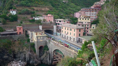 Riomaggiore, Italy - June 11. 2021: People boarding Passenger Train in Italy. Cinque Terre Train Line