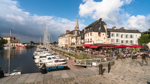 Honfleur, France - July 28, 2021: Time lapse in port of Honfleur, a french commune in the Calvados department and famous tourist resort in Normandy. Especially known for its old port.