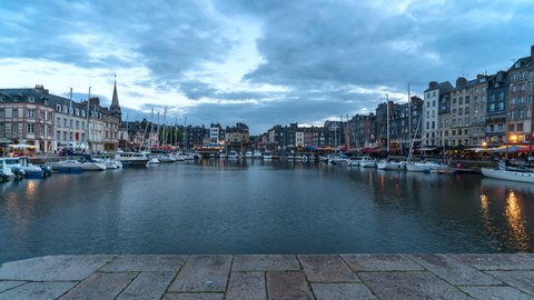 Honfleur, France - July 28, 2021: Evening time lapse in port of Honfleur, a french commune in the Calvados department and famous tourist resort in Normandy. Especially known for its old port.