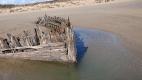 Shipwreck on the Cefn Sands beach at Pembrey Country Park in Carmarthenshire South Wales UK, which is a popular Welsh tourist travel resort and coastline landmark, video footage clip