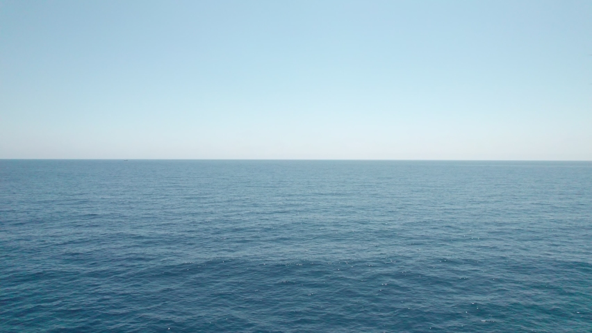 Flight over the sea. The endless horizon below us, only the blue depths. | Shutterstock HD Video #1077431636
