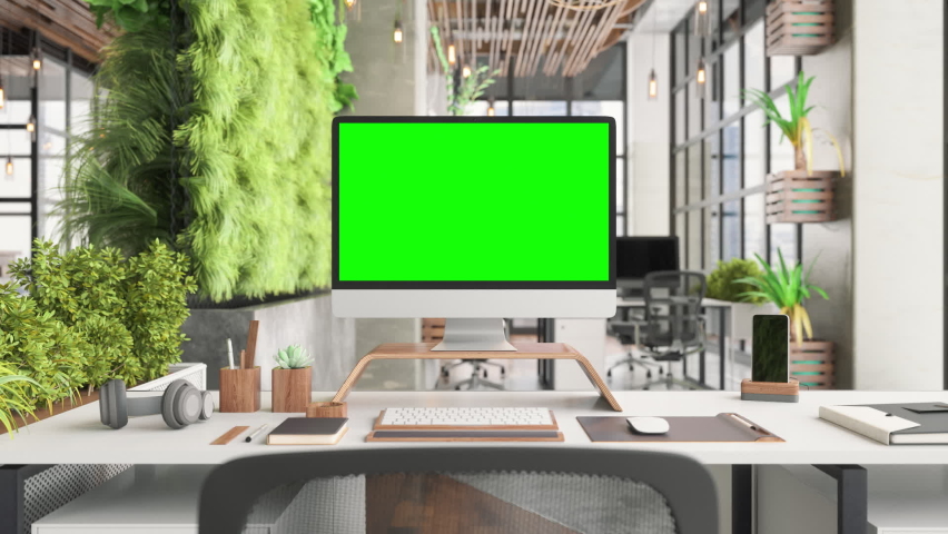 Green Computer Screen On Modern Office Desk In Sustainable Green Co-working Office Space Royalty-Free Stock Footage #1077434018