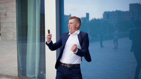 Businessman Looking Phone Screen Celebrating Success Excited Caucasian Male Business Person Win Online Casino Overjoyed Feel Euphoric Receiving Pleasant Message Smartphone Outdoors Dancing Happy 
