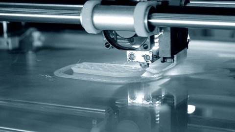 3d printer prints object close-up. Automatic three dimensional 3D printer