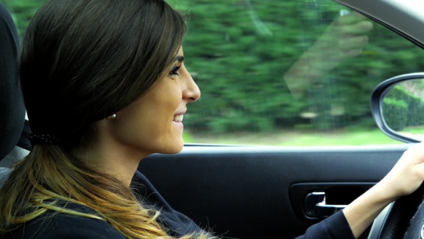 Woman smiling and talking while driving suv car | Shutterstock HD Video #1077445823