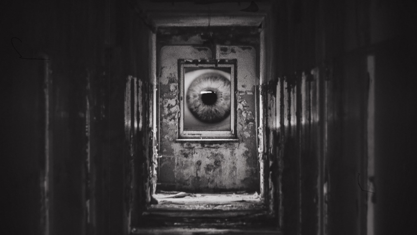 Spooky Eye Look Behind Window In Haunted House, Vintage Style. Ghostly eye looking through a window inside an haunted house. Eerie feelings