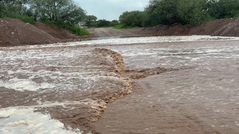 Closeup of flash flood flowing down a road in Arizona after monsoon