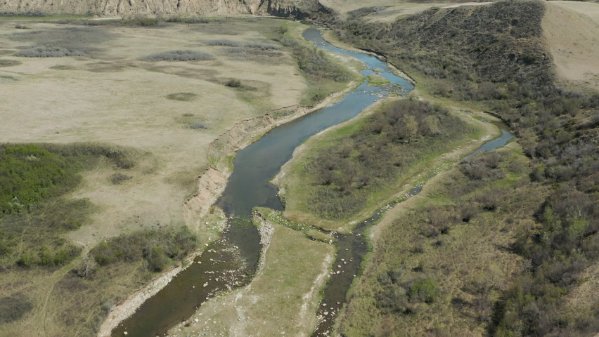 Wide aerial view of river breaks, surrounding scenery in Saskatchewan, Canada.