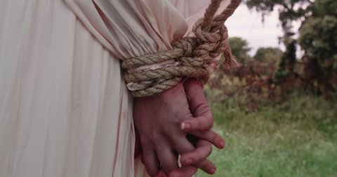 Woman With Her Hands Tied
