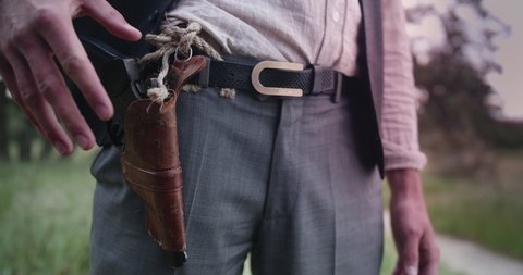 Closeup of a Cowboy Drawing Pistol In A Duel