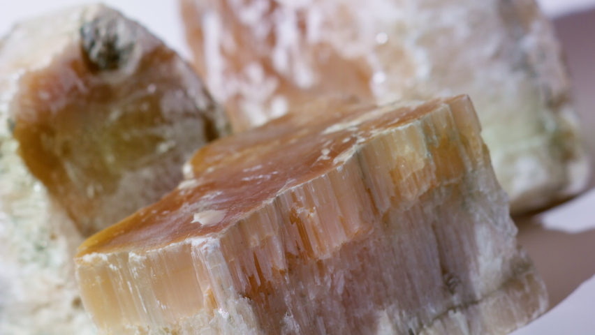 Large crystals of gypsum. Stones of plaster on a white background. Stones for the manufacture of building material. Raw materials for construction and decoration of premises and buildings