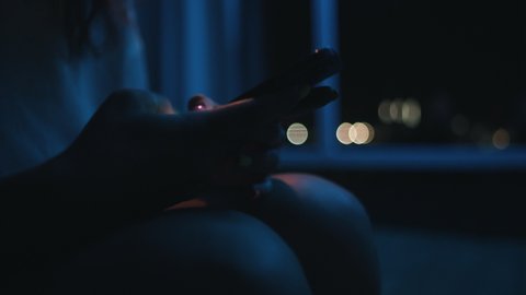girl typing a message at night