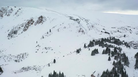 Cabin On Hilly Forest Landscape Densely Covered With Snow In Winter Park, Colorado Rocky Mountains. - Aerial Drone Shot