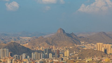 Time lapse: Wide angle Mecca landscape view during day from afar overlooking Makkah city skyline in Saudi Arabia with the Jabal Al Nour in the background. Zoom in motion timelapse.