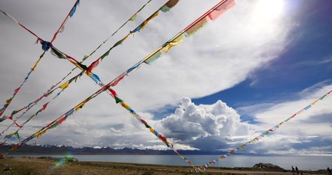 4k huge clouds mass rolling over lake namtso  Tanggula snow mountain peak,tibet mansarovar,pray flag in wind,Tibet's second largest lake,is the third largest saltwater lake in China.Danggula(Tanggula)