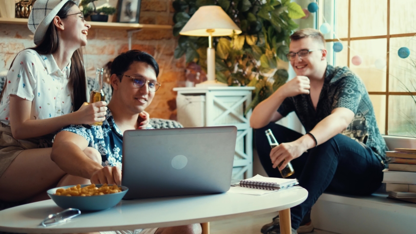 Group of teenagers watching a movie or entertainment program on a laptop