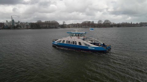 Amsterdam, 14th of March 2021, The Netherlands. GVB public transport ferry crossing the Ij river aerial. Following the ferry.