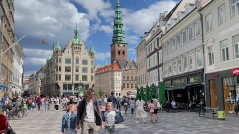 Copenhagen, Denmark, August 2021-Crowds of people walking down the Stroget street in Copenhagen on a sunny day
