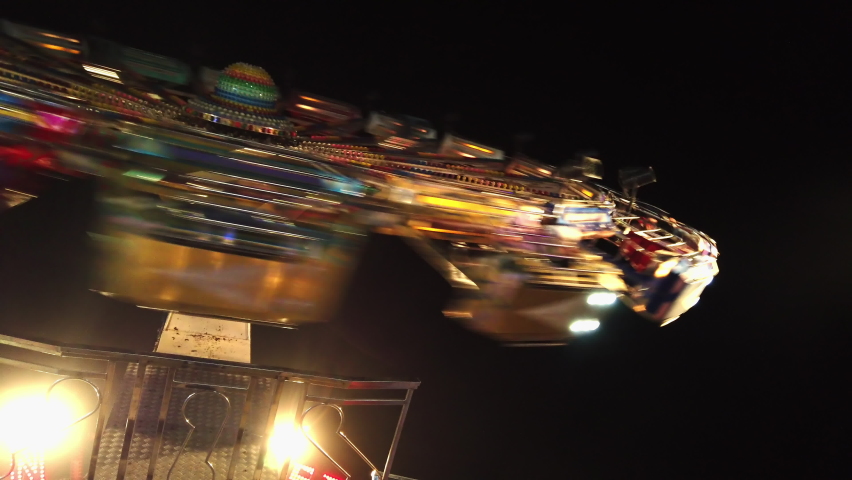 Illuminated Ferris Wheel adrenaline ride at amusement park at night Royalty-Free Stock Footage #1077483053