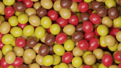 Multicoloured sugar sweets, candy beans or peanuts. Colorful candies filling all the area. Close up video. Holiday mood. Tasty assorted yellow, red, brown colored sweets. 3D Render clip. 4K animation
