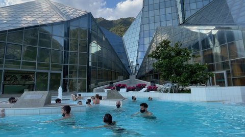 La Vella, Andorra, July 2021-People enjoying thermal bath outdoors in the Caldea spa in Andorra La Vella
