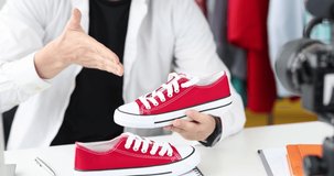 Male blogger recommends stylish red sneakers online 4k movie