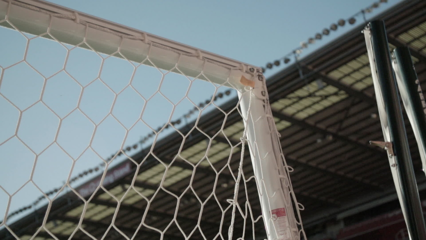 Slow motion footage of the corner of a goal used in soccer football, goal posts within a stadium environment. Royalty-Free Stock Footage #1077493001