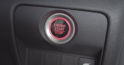 Automobile start-stop engine button glowing red after a single push (with pressing a brake pedal). Index finger push an automatic start engine to start or ignite the internal combustion engine system Arkivvideo