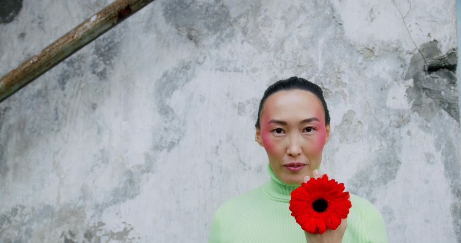 Asian girl posing with flower, skin care concept, beauty spa, bio product.