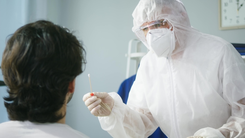 PCR test process, Doctor wearing protective suit and gloves taking sample from nose of patient for antigen coronavirus test, express covid-19 testing for traveling in airport, safety protection Royalty-Free Stock Footage #1077518261
