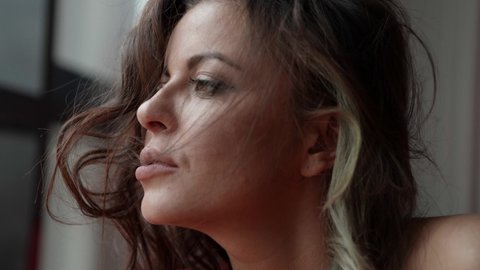 portrait of thoughtful sexy brunette woman, closeup of face, tousled hair after sleep