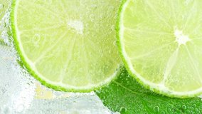 Super Slow Motion Shot of Pouring Water on Lime Slices and Ice Cubes in Glass at 1000 fps. - Powered by Shutterstock - Get 15% off with code: PIKWIZARD15