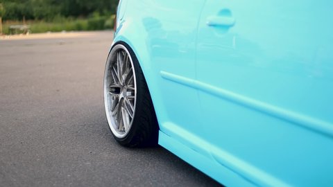 a mint-colored stance coupe with wide rims