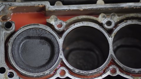 Disassembled motor engine of a car on a repair at the mechanic.The cylinder block of the four-cylinder engine. Closeup